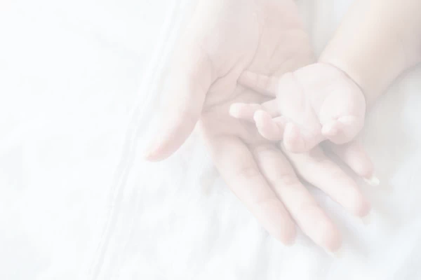 A baby's and mother's hands.